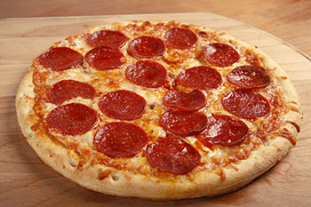 a pepperoni pizza on a wooden pizza peel