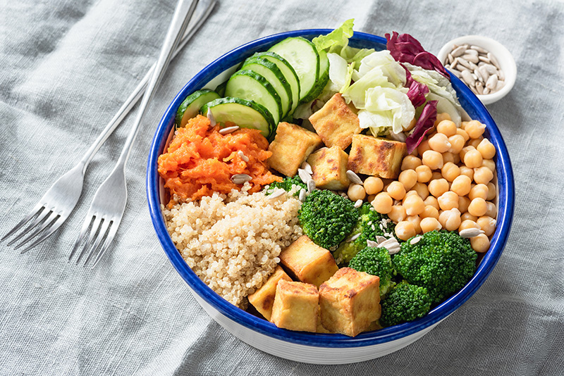 a bowl of tofu, vegetables, legumes and whole grains