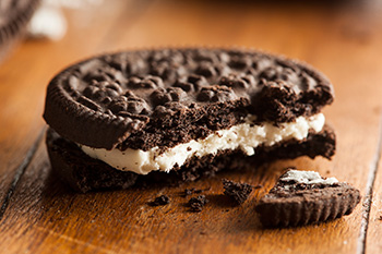 a closeup of an oreo cookie with a bite taken out of it