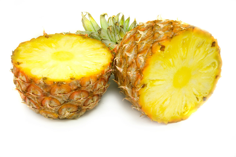 a fresh pineapple, sliced in half horizontally