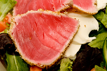 seared slices of fresh tuna on a bed of lettuce