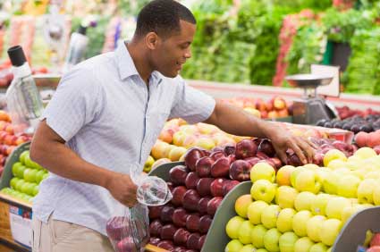 Man choosing fruit at a grocery store