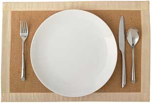 a place setting with a plate, fork, knife, and spoon
