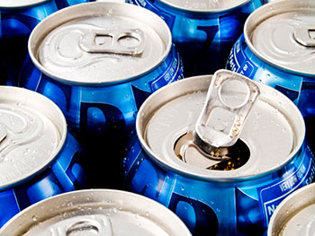 several carbonated beverage cans, seen from above