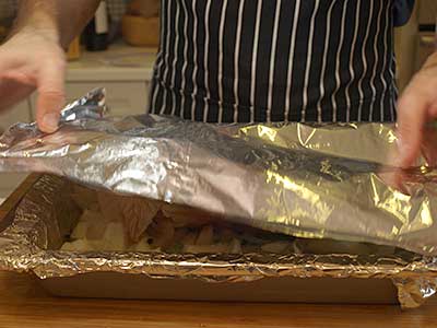 Cover the turkey breast with foil.