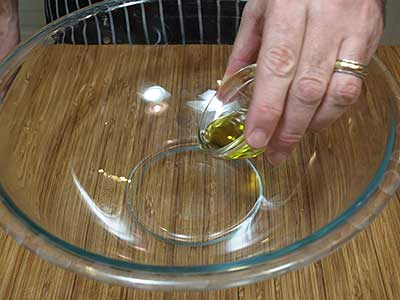 Add the olive oil to a large bowl,
