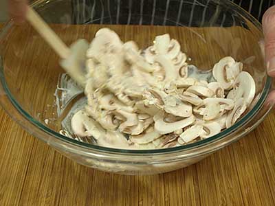 coating the mushrooms with the dressing.