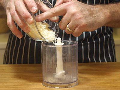 Add the grated parmesan to a blender or mini-chopper.