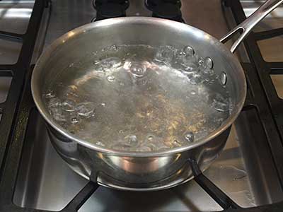 Place the water in a large sauce pan over high heat.