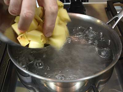 Cut the potatoes into about 1 inch cubes and add to the simmering water.