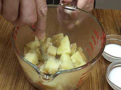 Drain the potatoes and place in a large bowl.