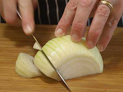 Repeat slicing each wedge around the circumference of the onion. 