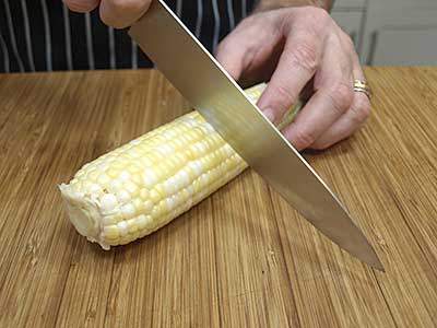 Cut the ear of corn in half.