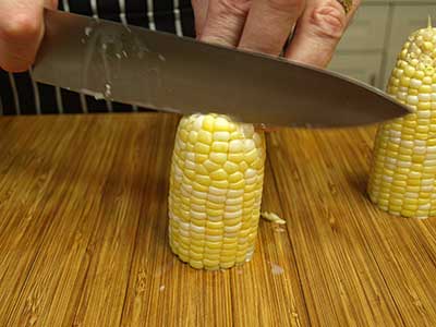 Place the ear of corn on a cutting board cut side down.