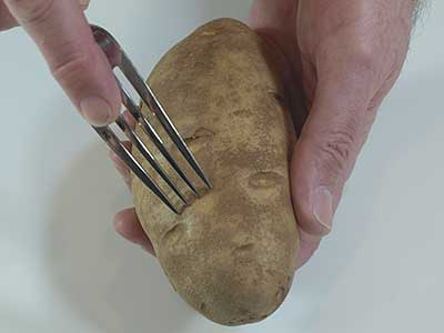 Use a fork to poke a few holes in the potato, then place in the preheated oven to bake.
