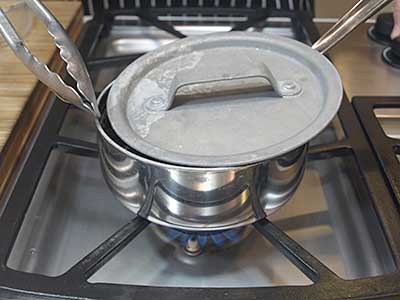 Reduce the heat and partially cover the pan, as above.