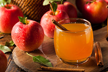 red apples and a glass of apple cider