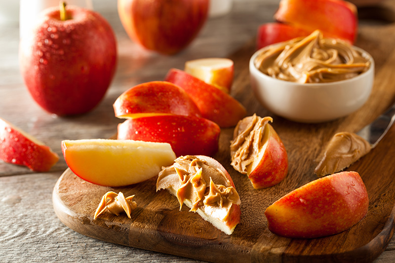sliced red apples topped with peanut butter