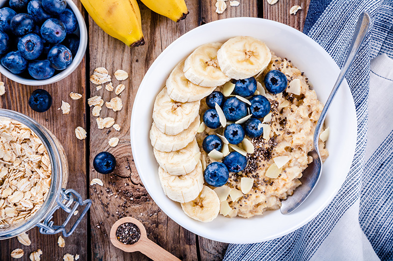 blueberries and sliced bananas on a bowl of oatmeal