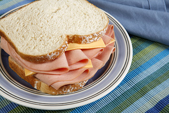 a bologna and American cheese sandwich on white bread