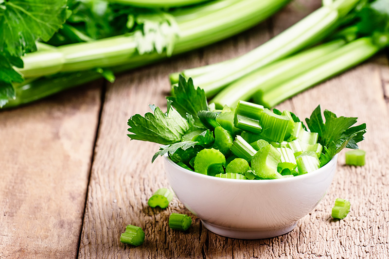 diced celery in a white bowl