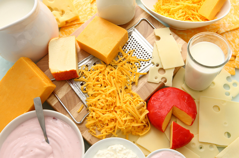 an assortment of dairy products, including cheeses, milk, and butter