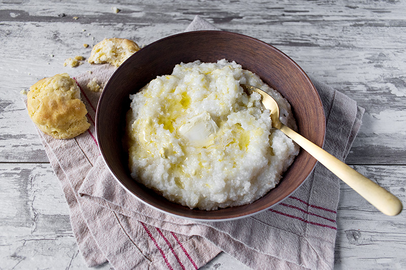 a bowl of grits topped with butter