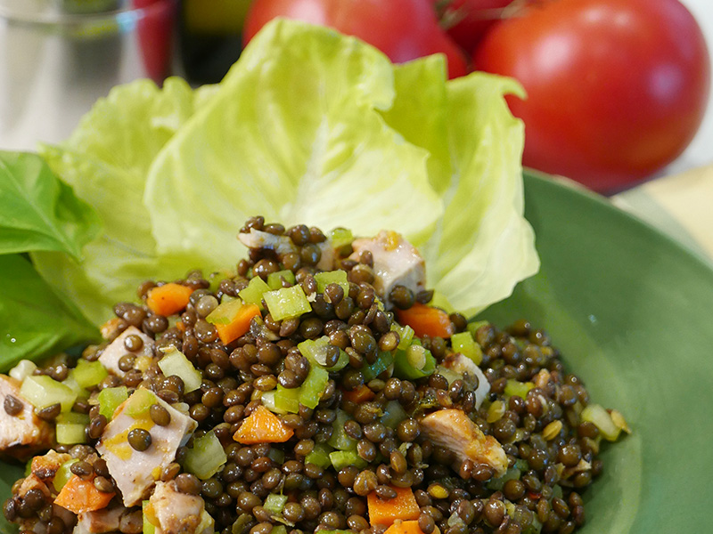 a salad of lentils, chicken, and vegetables