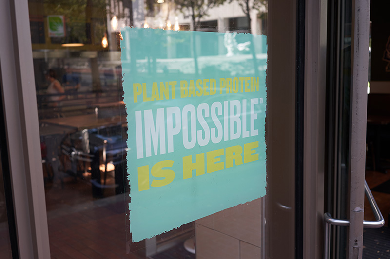 a fast food restaurant advertises the availability of the 'impossible burger' at that location