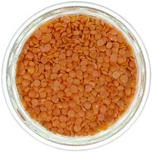 a clear glass bowl full of red (orange) lentils