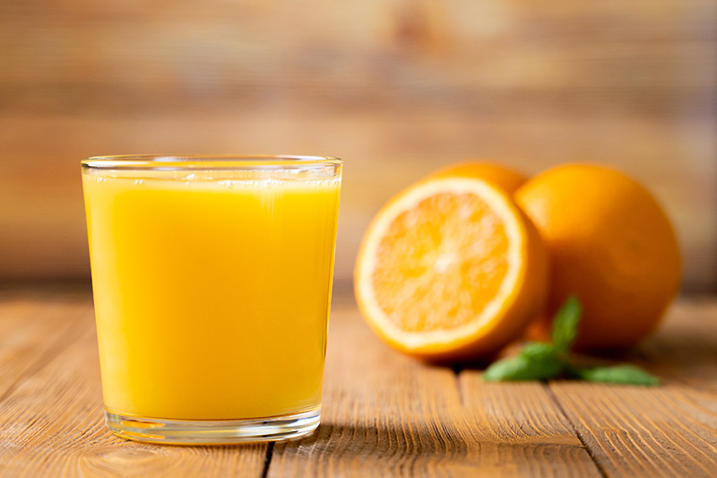 a glass of orange juice, a common source of Vitamin C