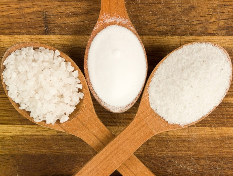 Three different types of salt in three wooden spoons