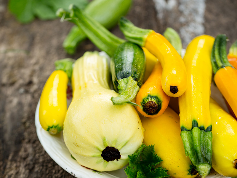 a variety of summer squash on a plate