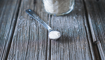 salt in a measuring spoon