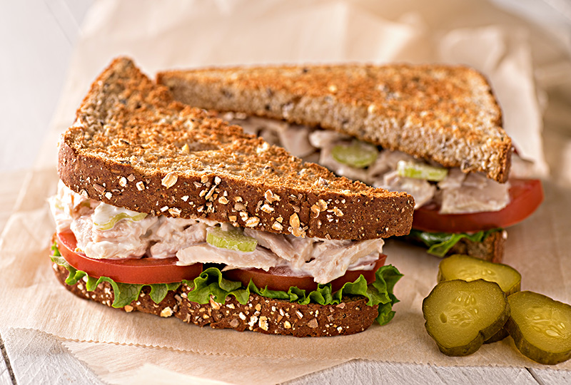 a tuna salad sandwich on toasted wheat bread