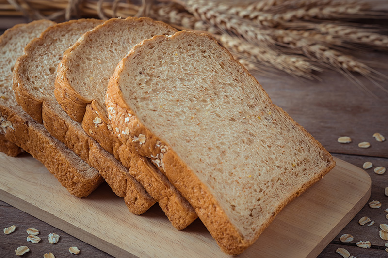 a loaf of whole wheat bread, sliced