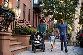 an African-American family of four takes a walk in the city